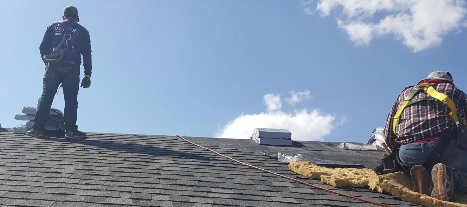 US Roof crew member re-roofing a Billings home